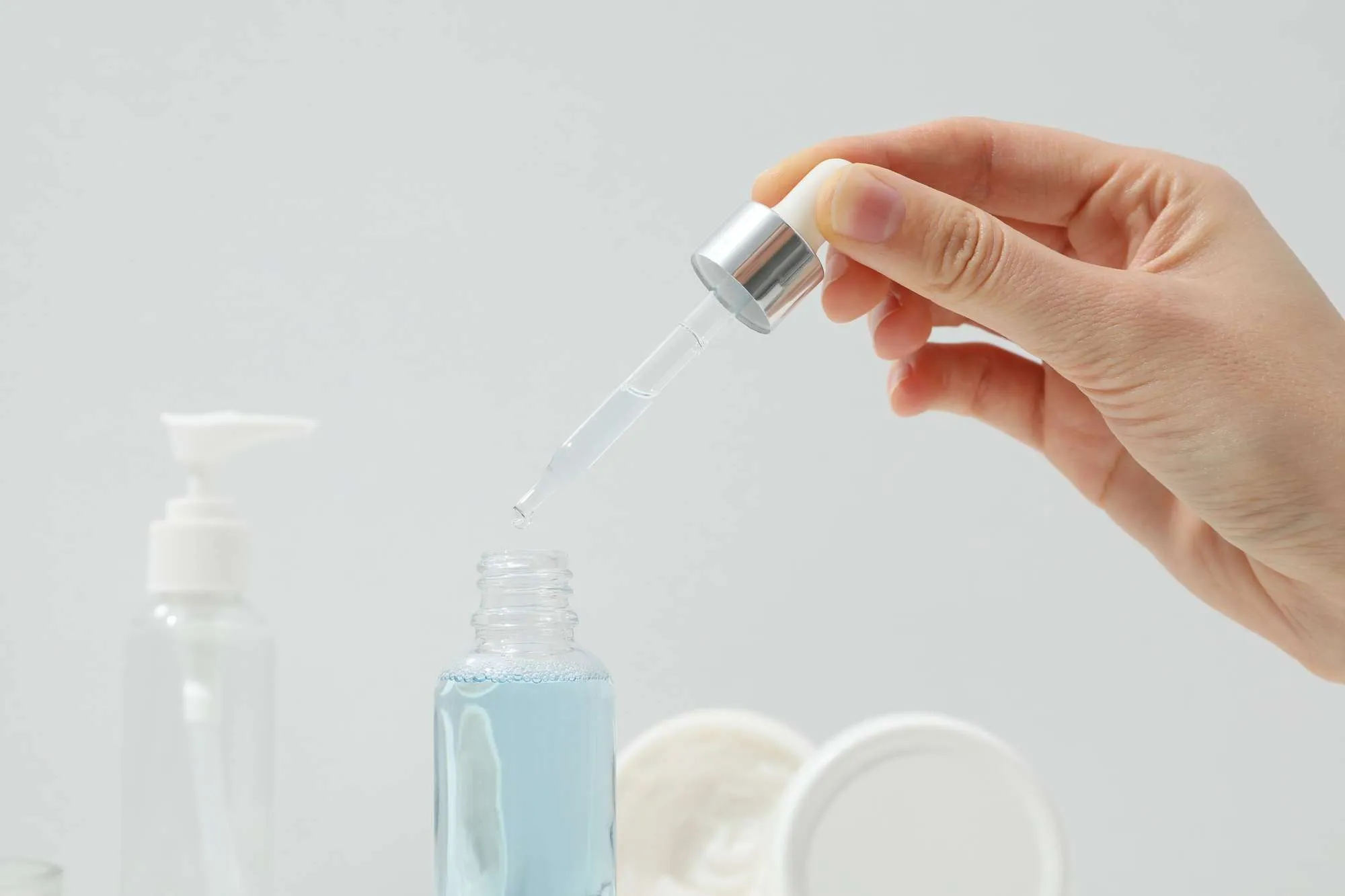 Cosmetics with a dropper on a light background